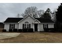 Charming one-story house with a gray exterior, black shutters, and well-manicured lawn at 637 Waterford Dr, Clayton, NC 27520