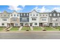 Row of townhouses showcasing modern design and landscaping at 701 Lucky Clover Way, Fuquay Varina, NC 27526