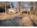 Exterior shot of a house with neutral siding and overgrown front yard at 1109 Mays Chapel Rd, Bear Creek, NC 27207