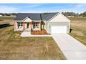 Aerial view of a charming single-Gathering home with a two-car garage and landscaped yard at 137 Glenwood Pl, Kenly, NC 27542