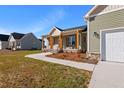 Well maintained home with a covered porch, two car garage, and lovely landscaping at 137 Glenwood Pl, Kenly, NC 27542