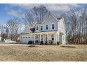 Well-maintained two-story home with a side-entry garage and a partially covered front porch at 221 Old Hickory Dr, Raleigh, NC 27603