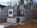 Charming two-story home features a stone facade, attached two-car garage, and neatly landscaped front yard at 3275 Roundly Rd # 10, New Hill, NC 27562