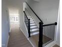 Bright entryway boasts a staircase with dark banisters and white risers leading to the upper level at 3275 Roundly Rd # 10, New Hill, NC 27562