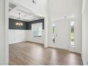 Bright foyer features an elegant chandelier and a view into the adjacent dining room at 38 Hewitt Woods Dr, Clayton, NC 27527