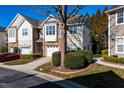 Two-story townhome with stone accents and a two-car garage at 4936 Lady Of The Lake Dr, Raleigh, NC 27612