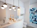 Spa-like bathroom with double vanity and blue tile shower at 507 Yancey St # 403, Durham, NC 27701