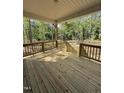 Relaxing wooden deck overlooking a lush, wooded backyard at 65 Watermelon Dr, Franklinton, NC 27525