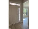 Elegant front door with glass panels and transom window at 65 Watermelon Dr, Franklinton, NC 27525