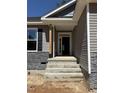 Welcoming front entrance featuring stone accents and a covered porch, leading into a spacious home at 65 Watermelon Dr, Franklinton, NC 27525