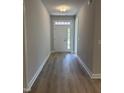 Inviting hallway features light grey walls and wood-look flooring at 65 Watermelon Dr, Franklinton, NC 27525