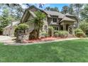 Brick home with stone accents and a manicured lawn at 6729 Greywalls Ln, Raleigh, NC 27614