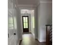 Elegant entryway featuring hardwood floors, shiplap walls, and a stylish dark front door at 716 Spirit Hill Dr, Hillsborough, NC 27278