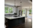 Spacious kitchen with a large center island, modern appliances, stylish light fixtures, and natural light at 716 Spirit Hill Dr, Hillsborough, NC 27278