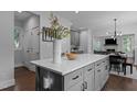 Kitchen island with gray cabinetry, white countertops, and seating for three to the adjacent dining area at 727 Martin Luther King Jr Blvd Blvd, Raleigh, NC 27601