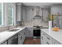 Modern kitchen featuring gray cabinets, stainless steel appliances, and a stylish backsplash at 727 Martin Luther King Jr Blvd Blvd, Raleigh, NC 27601