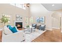 Spacious living room with a fireplace, comfortable seating, and plenty of natural light at 7945 Parker Mill Trail, Fuquay Varina, NC 27526