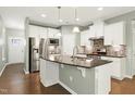 Spacious kitchen with an island, stainless steel appliances, and hardwood floors at 1009 Santiago St, Durham, NC 27703