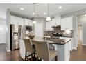 Kitchen featuring stainless steel appliances, white cabinets, and granite counters at 1009 Santiago St, Durham, NC 27703