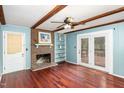 Living room with fireplace, built-ins, hardwood floors, and access to deck at 101 Monterey Ln, Durham, NC 27713