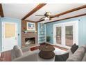 Living room with fireplace, built-ins, hardwood floors, and access to deck at 101 Monterey Ln, Durham, NC 27713