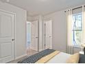 Bright bedroom with two doors and a window, offering versatility at 1058 Winding Spring Dr, Mebane, NC 27302