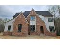 New construction with brick and siding features black window frames and architectural details at 109 Evander Way, Pittsboro, NC 27312