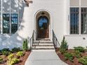 Inviting front entrance featuring a arched doorway and stone steps at 109 Evander Way, Pittsboro, NC 27312