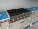 A professional range with white cabinets sits on top of a light blue countertop at 129 Windel Dr, Raleigh, NC 27609