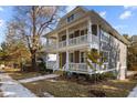 Two-story house with gray siding, white trim, and a wraparound porch at 1300 Broad St # C, Durham, NC 27705