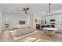 Open living room and kitchen with hardwood floors and modern appliances at 1300 Broad St # C, Durham, NC 27705