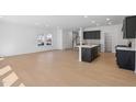 Open concept kitchen with dark cabinets, island, and stainless steel appliances at 2000 Regal Dr # 88, Durham, NC 27703