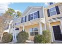 Two-story townhome with a covered porch and manicured landscaping at 207 Hampshire Downs Dr, Morrisville, NC 27560
