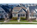 Lovely home showcasing its manicured front yard and inviting porch from an aerial perspective in a cozy neighborhood at 213 Quarter Gate Trace, Chapel Hill, NC 27516