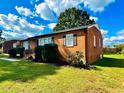Side view of brick ranch house showcasing its brick facade and lawn at 2923 Mckinney St, Burlington, NC 27217