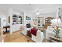 Cozy living room boasts hardwood floors, fireplace, and access to outdoor space at 3701 Baron Cooper Pass # 205, Raleigh, NC 27612