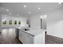 Island kitchen with a stainless steel dishwasher and spacious open floor plan at 433 Rowe Way, Knightdale, NC 27545