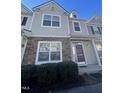 Two-story townhome with neutral siding and stone accents at 711 Keystone Park Dr # 58, Morrisville, NC 27560