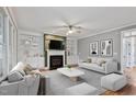 Inviting living room with fireplace, built-in shelving, neutral paint, and plush seating for relaxation at 7416 Capulin Crest Dr, Apex, NC 27539