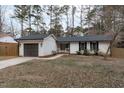 Ranch style home with white siding, dark gray garage door, and a well-manicured lawn at 1 Cates Ct, Hillsborough, NC 27278