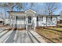 Inviting home with white siding, black shutters, and a covered porch, perfect for relaxing outdoors at 1014 Holden Rd, Youngsville, NC 27596