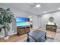 Inviting living room showcases stylish decor, a flat-screen TV, and seamless transition to other rooms at 1014 Holden Rd, Youngsville, NC 27596