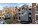 Exterior view of a townhome with brick and gray siding at 1061 Wirewood Dr # 102, Raleigh, NC 27605