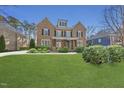 Charming brick home with a manicured lawn and mature landscaping creates excellent curb appeal at 109 Aspenridge Dr, Holly Springs, NC 27540