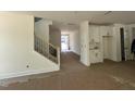 Spacious foyer featuring a staircase, built-in cabinets, and a view of the front door at 1105 Opal Ln # 70, Durham, NC 27705