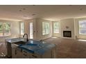 Open concept kitchen with a farmhouse sink and view into the living room and fireplace at 1105 Opal Ln # 70, Durham, NC 27705