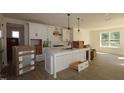 Bright, white kitchen with a center island, stainless steel appliances, and hardwood floors at 1105 Opal Ln # 70, Durham, NC 27705