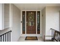 Elegant dark brown front door with glass panels and a wreath at 128 Bruce Dr, Cary, NC 27511