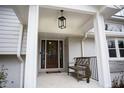 Inviting front porch with a bench and stylish lantern at 128 Bruce Dr, Cary, NC 27511