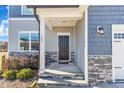 Dark brown front door with stone and siding accents at 148 Aylebury Rdg, Zebulon, NC 27597